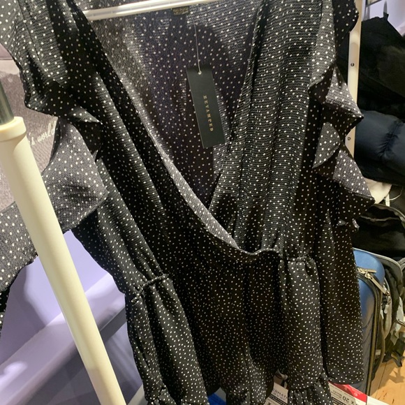 Long sleeve navy polkadot jumpsuit with cut out shoulders and frills - Picture 2 of 2